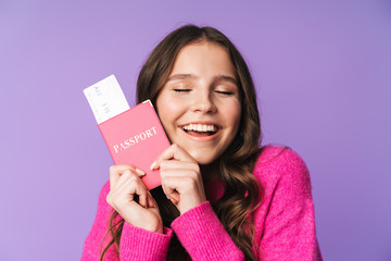 Naklejka premium Image of young beautiful woman holding passport and travel ticket
