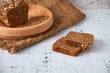 Village grey bread on a wooden plate