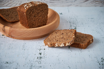 Village grey bread on a wooden plate