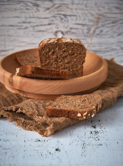 Village grey bread on a wooden plate