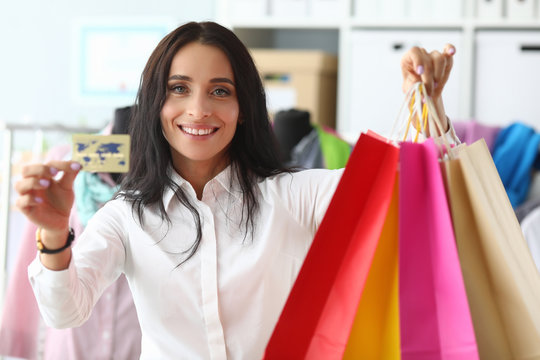 Stylish woman shows credit card and packages. Business shopper spends several days on personal work with client. Shopping with personal stylist is much more organized. Individual image counseling