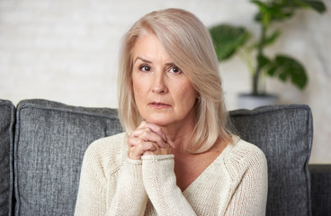 Portrait of a 60 years old pensive mature woman