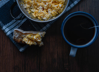 scrambled egg at breakfast with a cup of tea