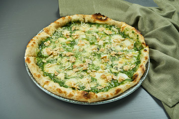 Close up view on Appetizing 4 cheese pizza with almands on wooden background in a restaurant. Italian cuisine. Close up with copy space