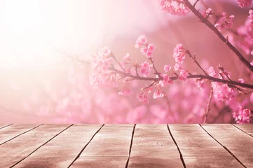Gordijnen Spring seasonal of pink sakura branch with wooden table stand ,flower background © OHishi_Foto