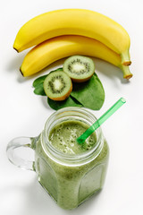 Green smoothie in a jar with a straw