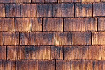 Facade covered with wooden shingles.