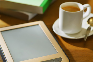 Fototapeta na wymiar E-reader with cup of coffee