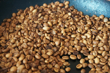 Coffee beans roasted to golden and brown are on the counter in the store