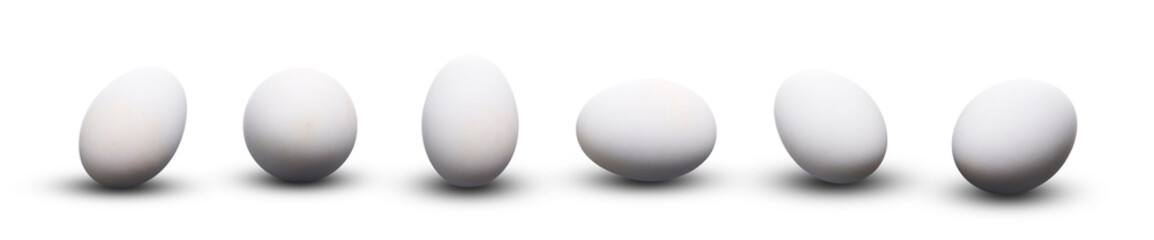 Whole fresh white chicken eggs isolated on a white background.