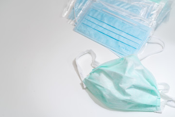 Surgical mask with rubber ear straps. Typical 3-ply surgical mask to cover the mouth and nose. Procedure mask from bacteria. Protection concept.