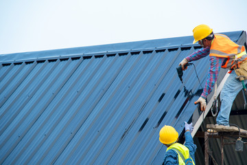 Construction worker wearing safety harness using secondary safety device connecting into 15 mm...