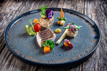 grilled sea bass fillet with cooked vegetables and potato pie