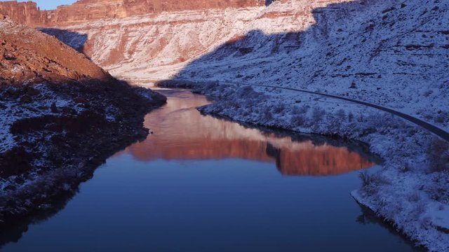 Aerial Footage of Colorado River and Reflection in Wintertime Near Moab, Utah U.S.A. Following Cars Flyover Drone Footage With Reflection