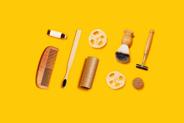 Ecological accessories for male body care on yellow background.