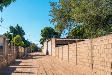 Sandy road in African neighborhood in Maputo, Mozambique
