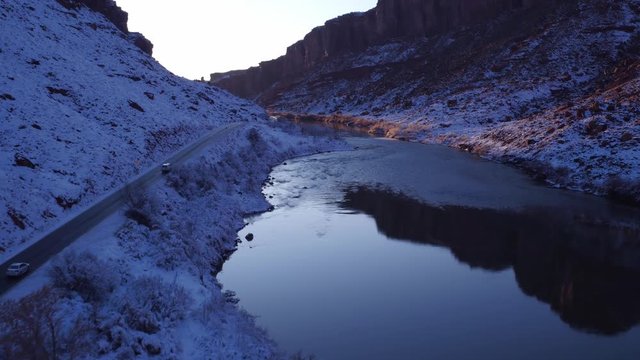 Aerial Footage of Colorado River in Winter Near Moab, Utah U.S.A. Following Cars Approaching Flyover Drone Footage