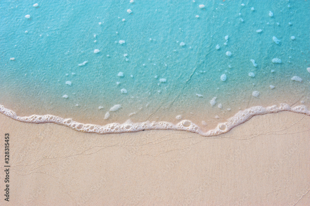 Poster blue ocean with soft wave form and fine sandy beach summer background concept