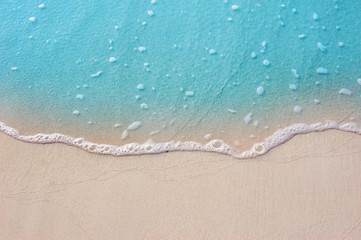 Fototapeta na wymiar Blue ocean with soft wave form and fine sandy beach Summer background concept