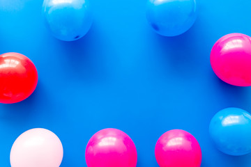 Decorative frame with colorful balloons on blue background top-down frame copy space