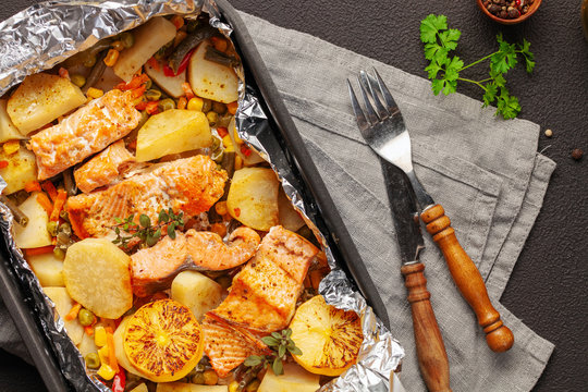Foil pack dinners. Salmon with vegetables baked in foil. Dietary food. Top view