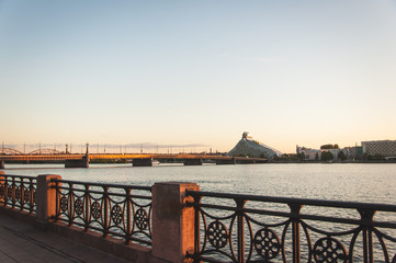Sunset on River Daugava with bridge and city skyline in the background