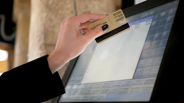 Waiter girl working with pos terminal or cashbox at cafe. People and service concept