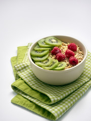 Oatmeal with fresh fruits on a white background.