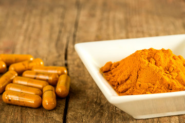 turmeric powder and capsules with mortar