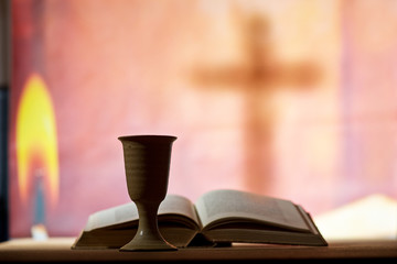 Still life with chalice of wine and open bible