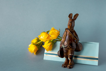 Copper hare-postman with postal horn and envelope with yellow roses