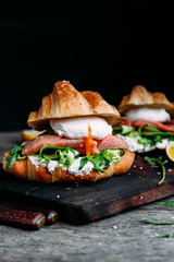 Croissant with salmon, cream cheese, poached egg and lettuce