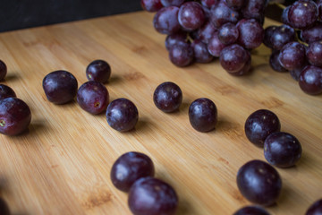 Grape on top of a wooden board