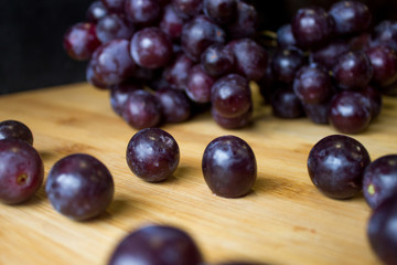 Grape on top of a wooden board