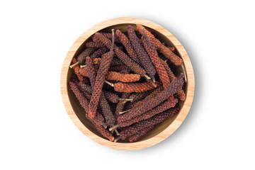 Dry Idian long pepper or Piper longum in wooden bowl isolated on white background with clipping path. Herbal medicine plant concept. 