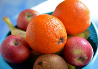 fresh fruits in a basket on wooden background