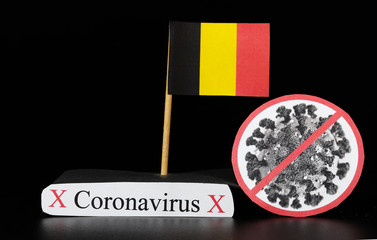 National flag of Belgium with cell of covid-19 and word coronavirus. Fast spreading disease worldwide. Covid-2019 is a stronger flu which affects seniors and sick people. Dangerous and agressive