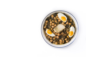Chickpea stew with spinach and cod or potaje de vigilia isolated on white background. Top view copy space