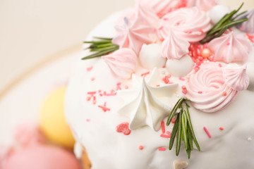 close up view of tasty Easter cake with rosemary and meringue on glaze
