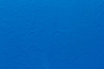 Abstract pattern and textured detail of fresh blue coloring on rough surface cement wall background.