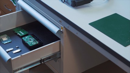 Gray table with microchips and mobile phone components
