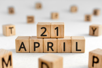 April 21 - from wooden blocks with letters, important date concept, white background random letters...