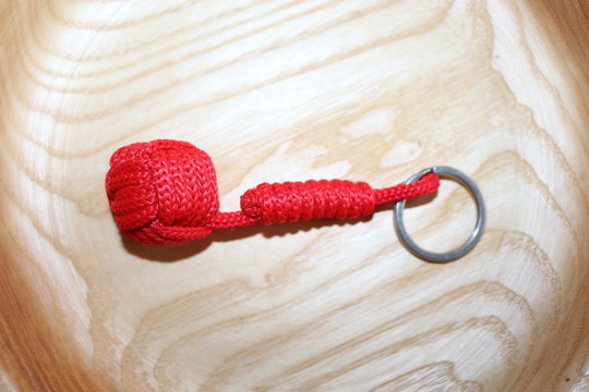 The keychain is made using macrame technique. The main knot is called monkey fist