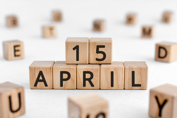 April 15 - from wooden blocks with letters, important date concept, white background random letters...