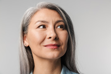 Image of adult woman with long white hair looking aside at empty space