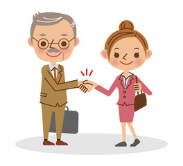 握手をするビジネスマン（シニア男性と若い女性）