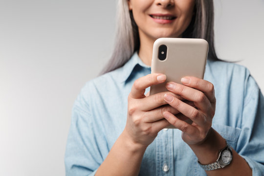 Image of adult mature woman with long white hair holding cellphone