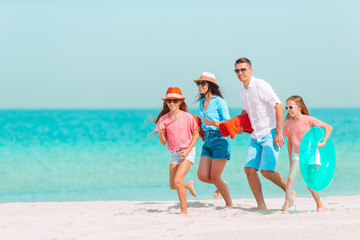 Photo of happy family having fun on the beach. Summer Lifestyle