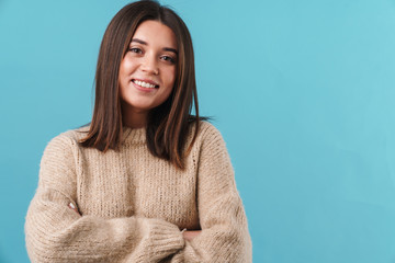Image of happy caucasian woman in sweater smiling and looking at camera