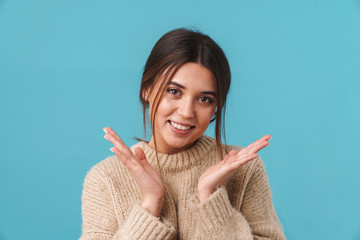 Image of happy caucasian woman in sweater smiling and looking at camera